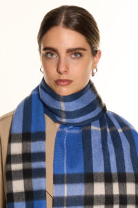 A blue cashmere scarf in a luxury handcrafted gift box.