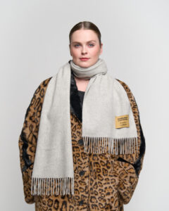 A mother wearing a luxurious cashmere scarf, showing elegance and warmth.