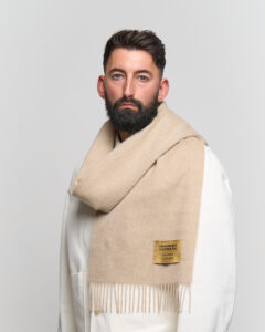 A cream-colored cashmere scarf in a stylish premium box.